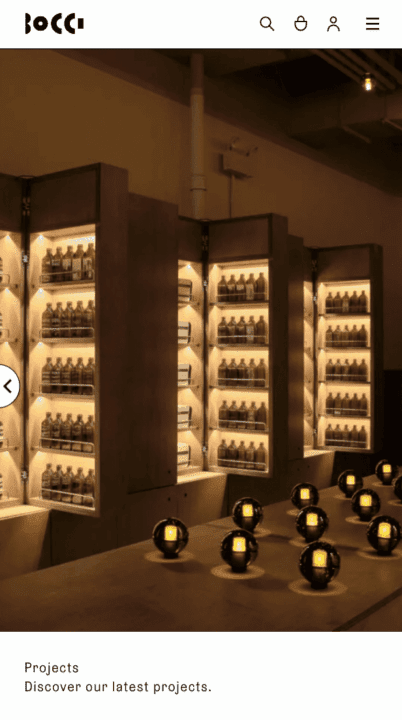 Modern interior with illuminated shelves displaying bottles and spherical lights in a w...